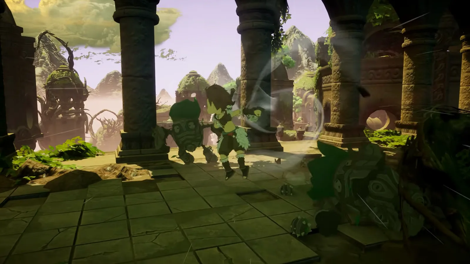 Two small characters moving through a ruined stone courtyard with misty mountains in the distance in the Winds of Viridia reveal trailer